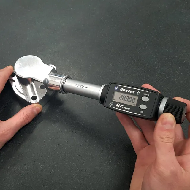 Bowers 3-point bore gauge inspecting the internal diameter of a machined thermostat housing
